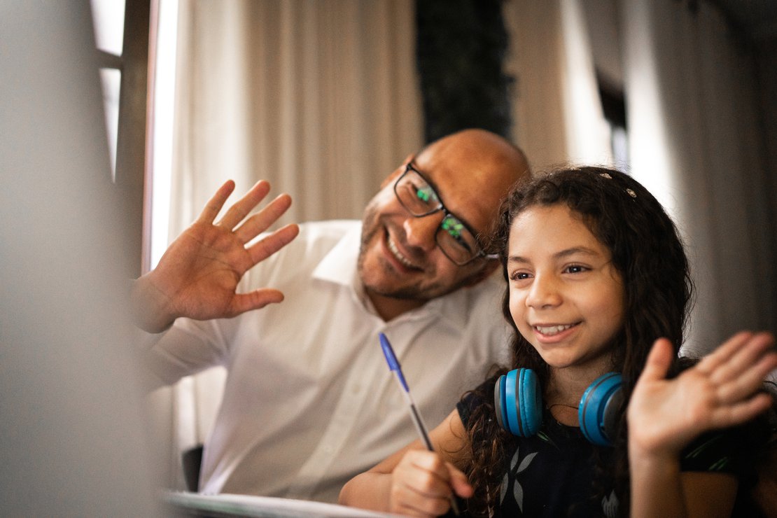 Man in white dress shirt wearing blue headphones