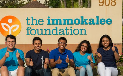 908, the immokalee foundation. Group of people sitting on bench